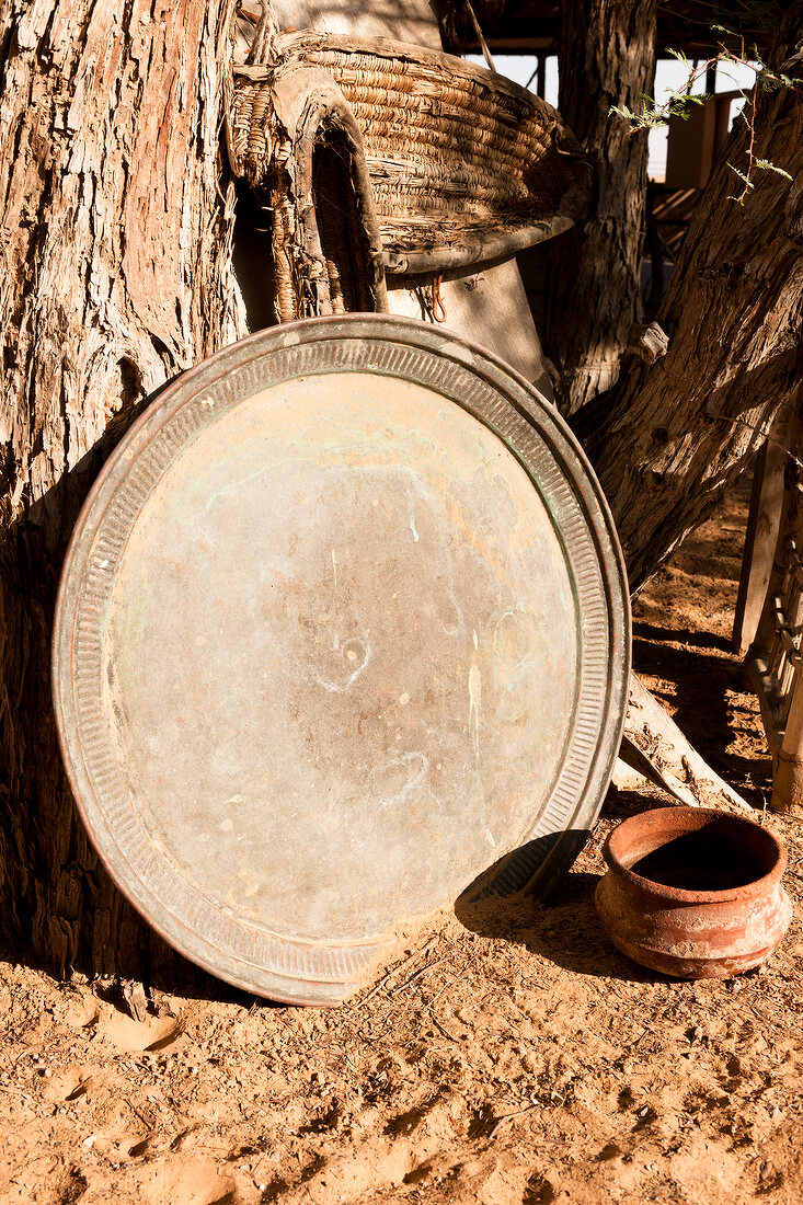 Oriental round tray with pot in front in Wahiba Sands, Oman