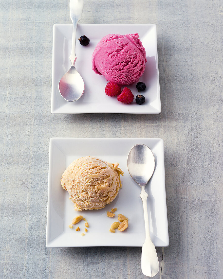 Frozen yogurt with berries and ground nuts on plates