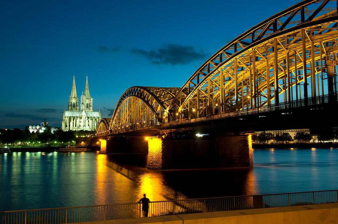 View of Rhine, Hohenzollern bridge and Cologne Cathedral at night in Cologne, Germany