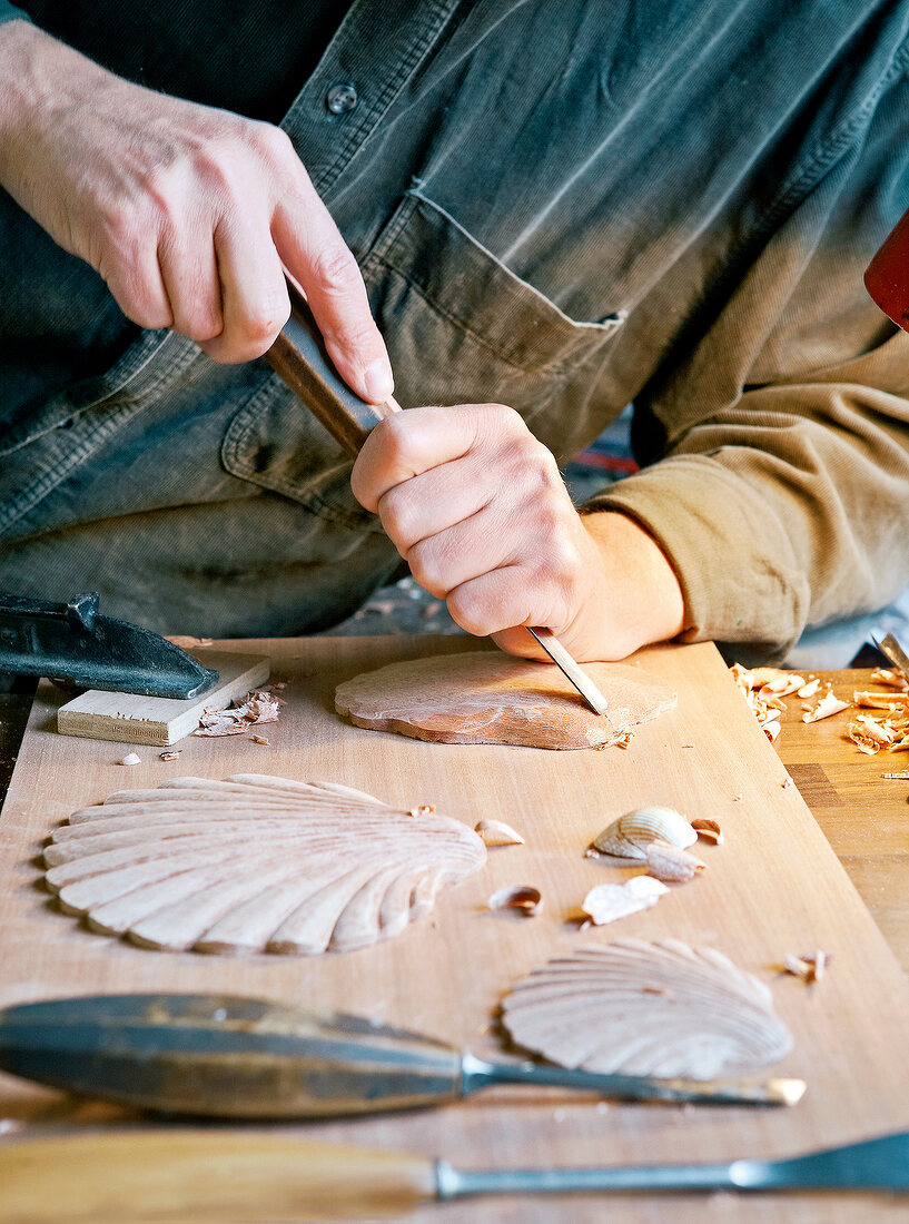 Man painting door with paintbrush in traditional style