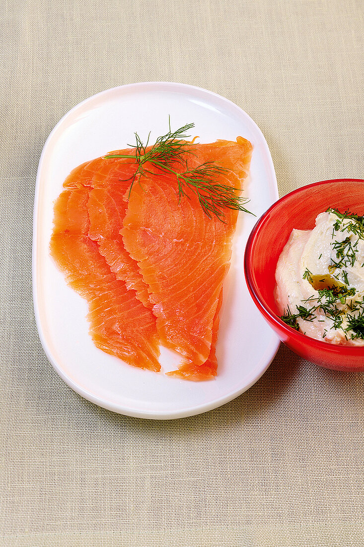 Smoked salmon with dill on tray and cottage cheese in bowl