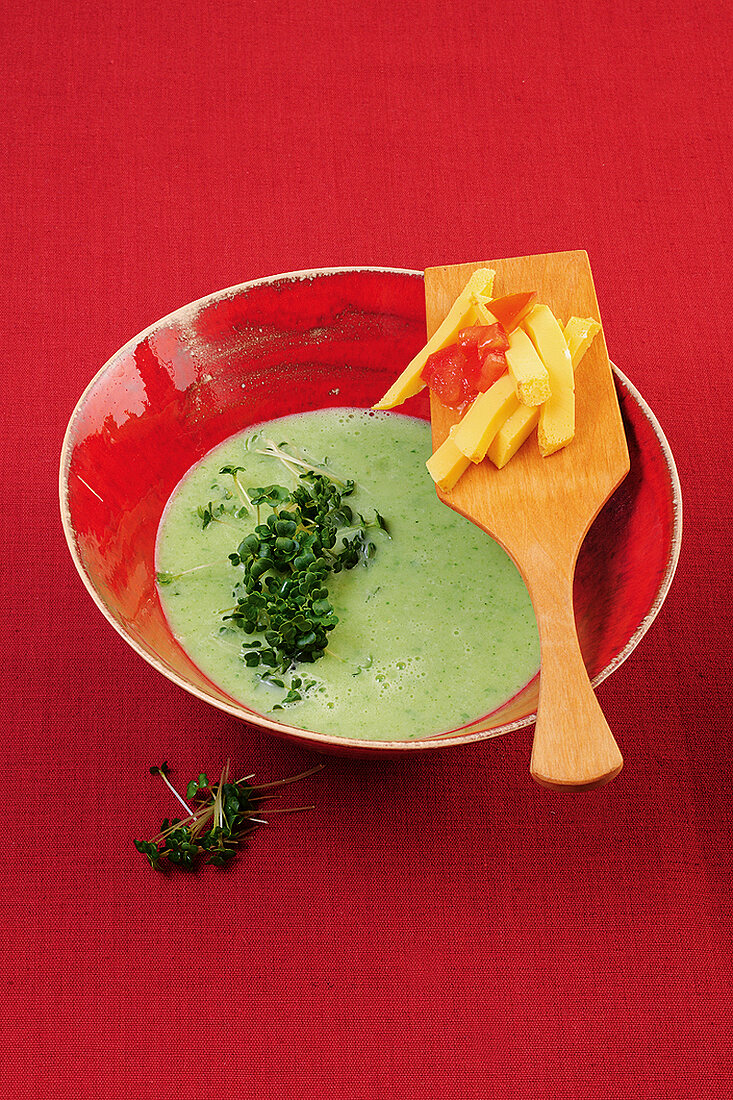 Broccoli soup with egg custard and herb in bowl