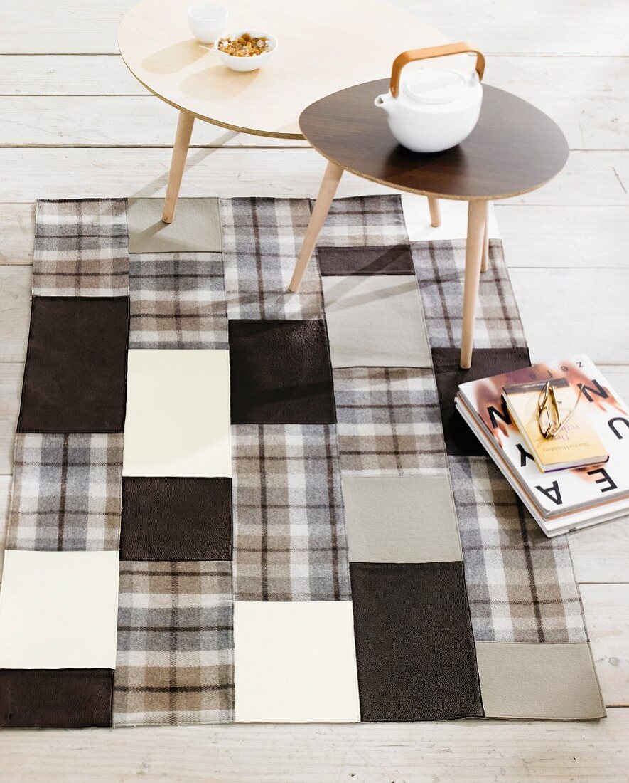 Hand-sewn patchwork rug made from squares of various monochrome fabrics