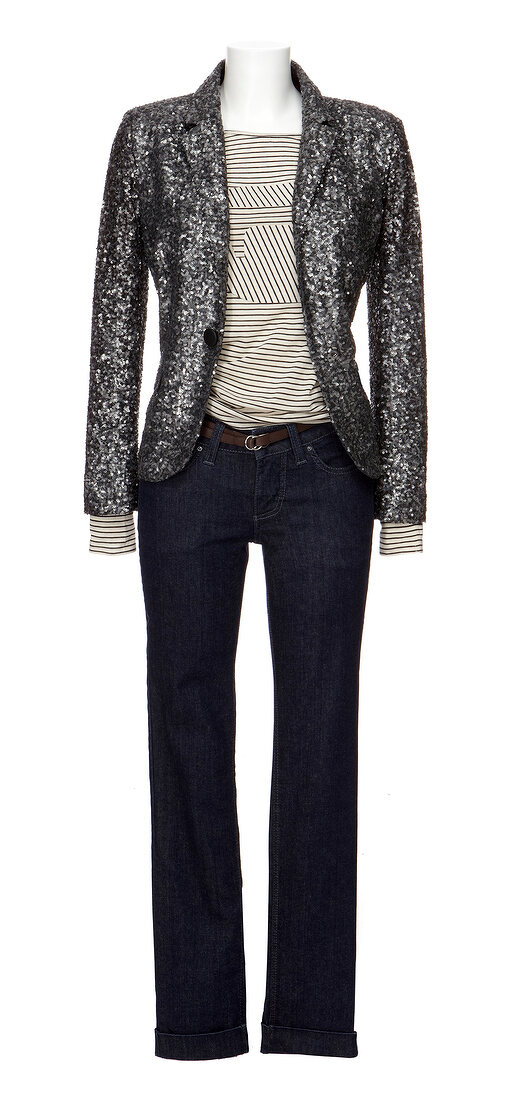 Black sequined blazer with patterned top and black jeans on white background