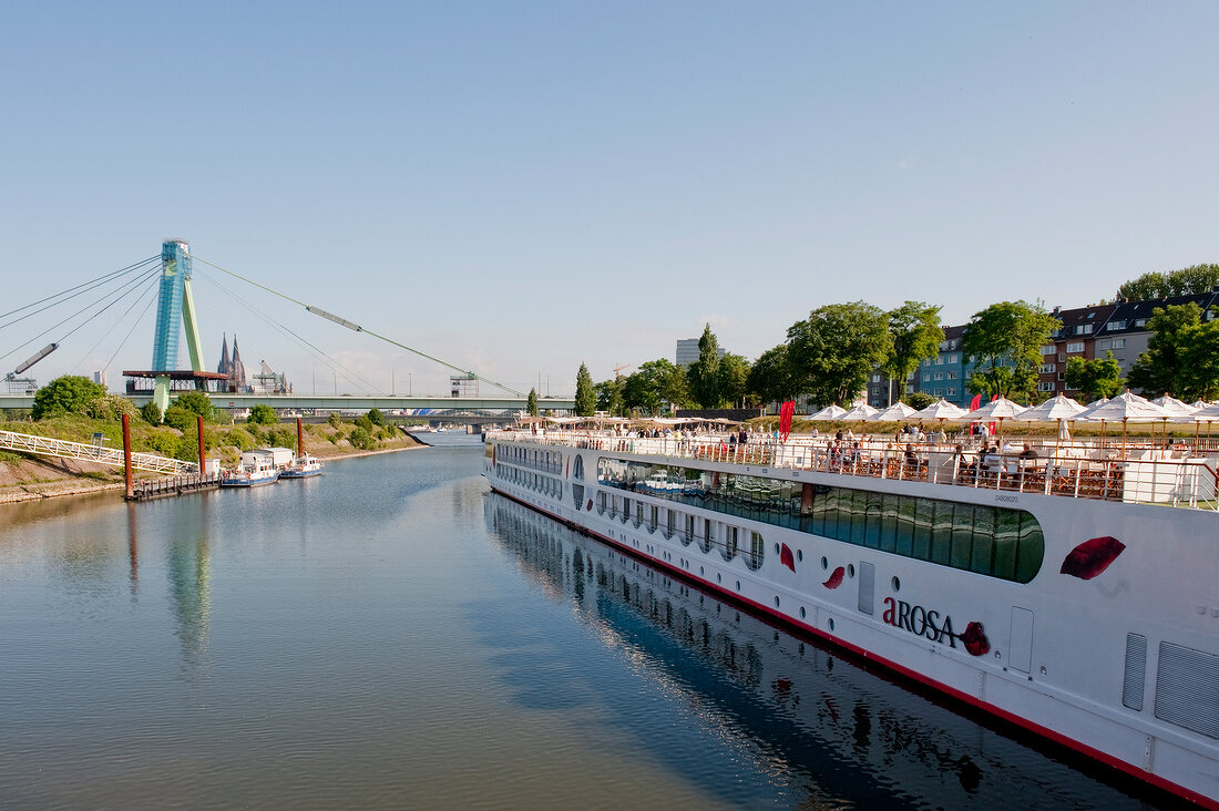 View of A-Rosa Viva river cruise ship in Rhine and Severin Bridge, Cologne, Germany