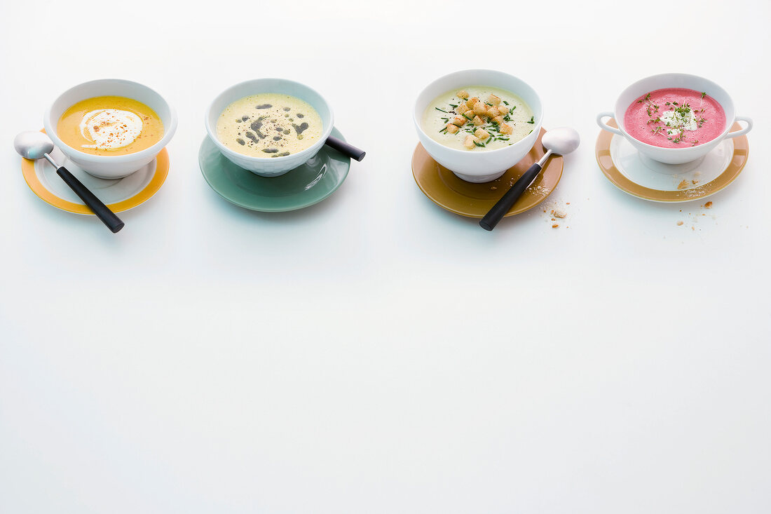 Four different cream soups in bowls
