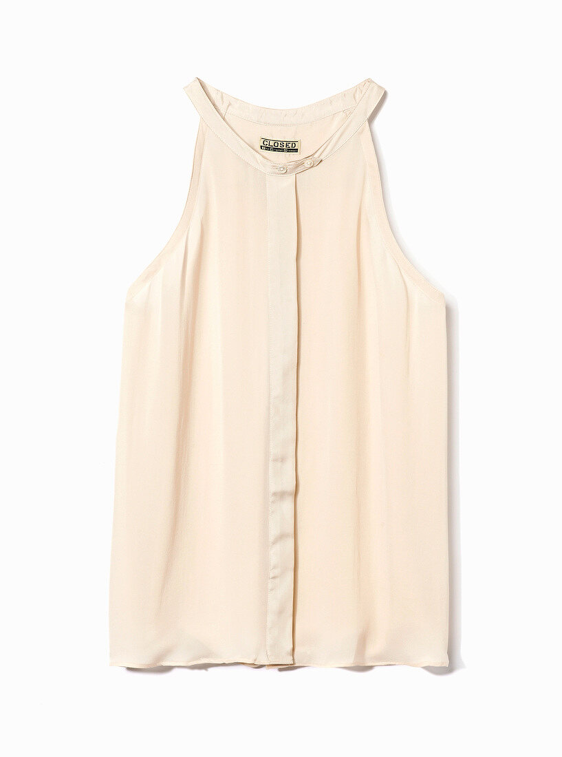 Close-up of sleeveless beige top on white background