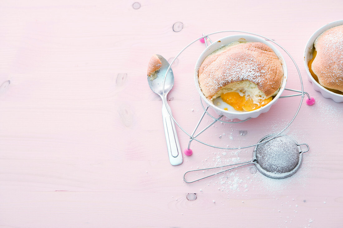 Peach souffle on grill on pink background, copy space