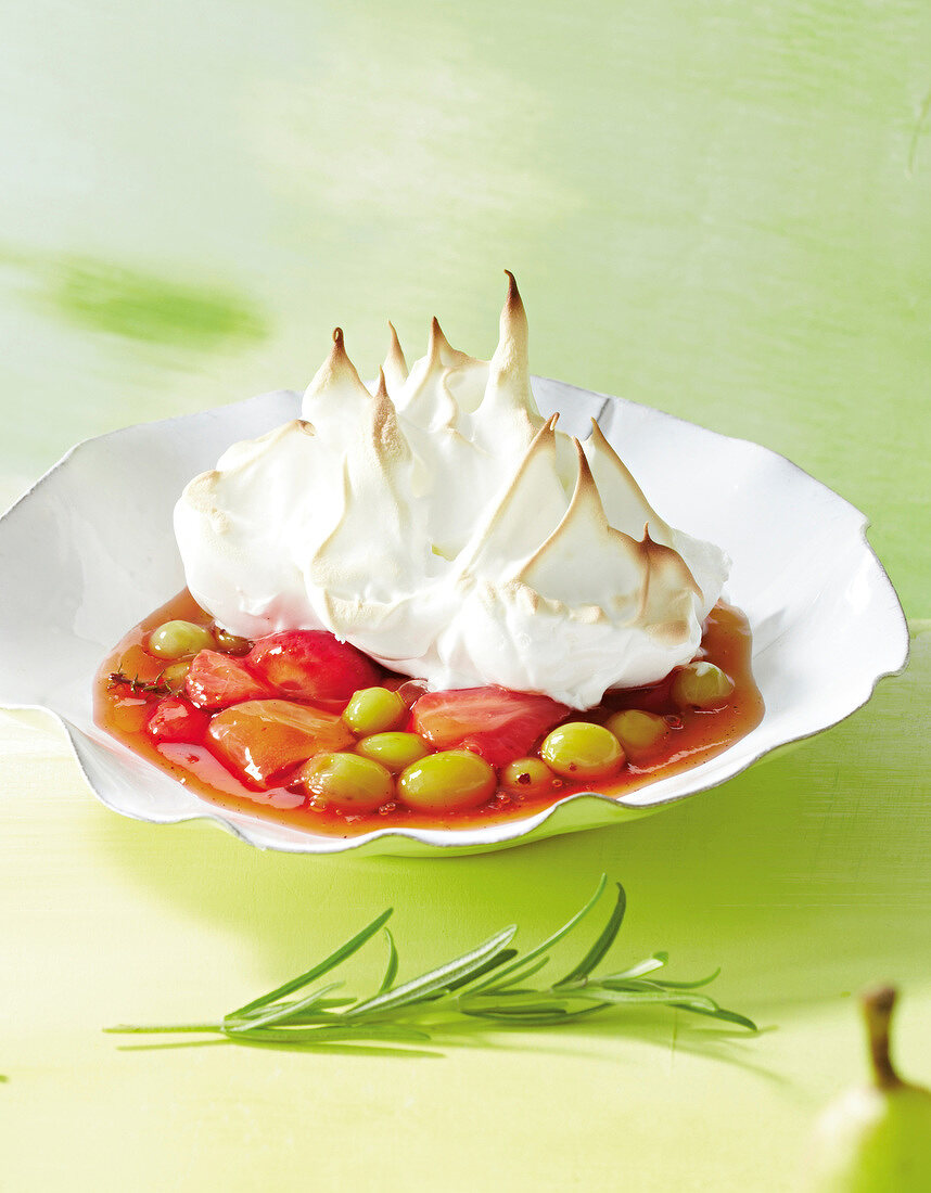 Summer fruit compote with meringue in bowl