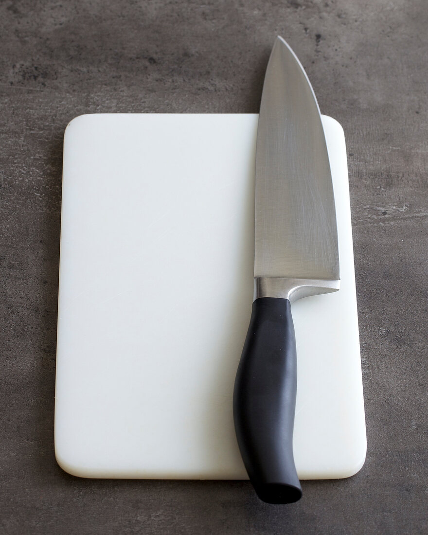 White cutting board with large knife