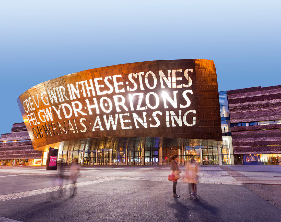 Illuminated exterior of Millennium centre in Cardiff at night, Wales, UK, blurred motion