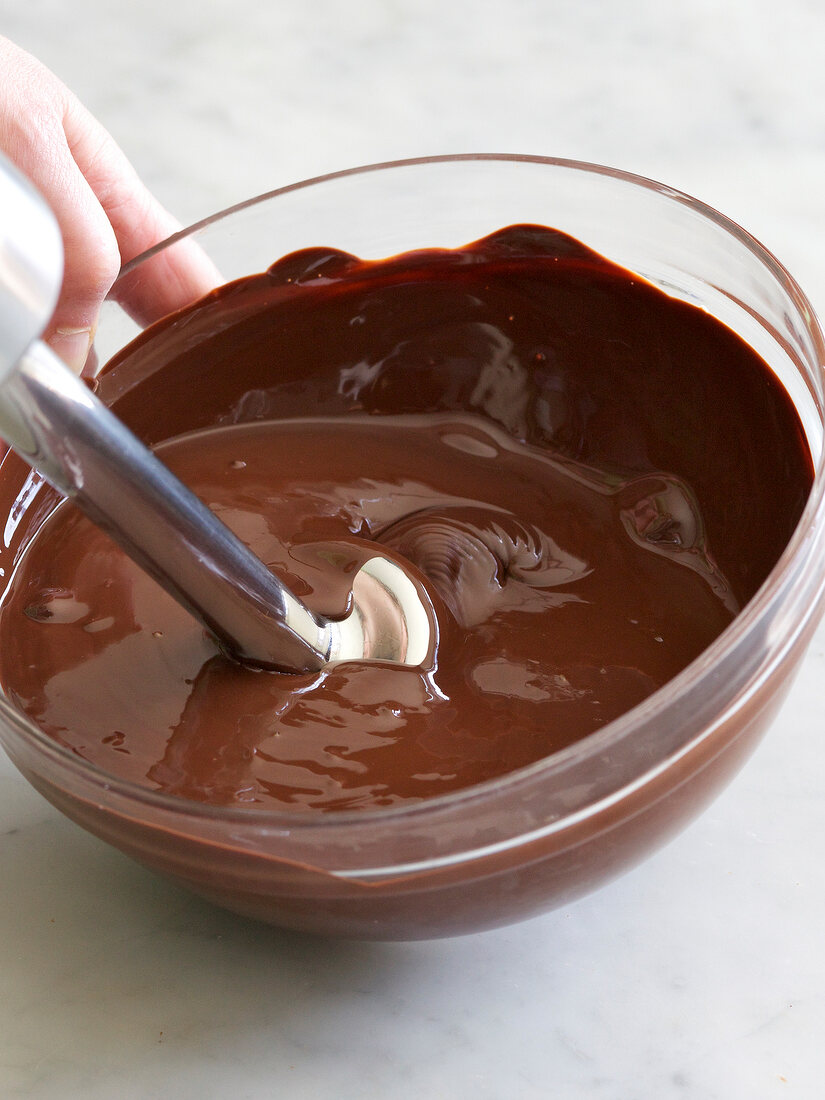 Melted chocolate being mixed in bowl, step 3