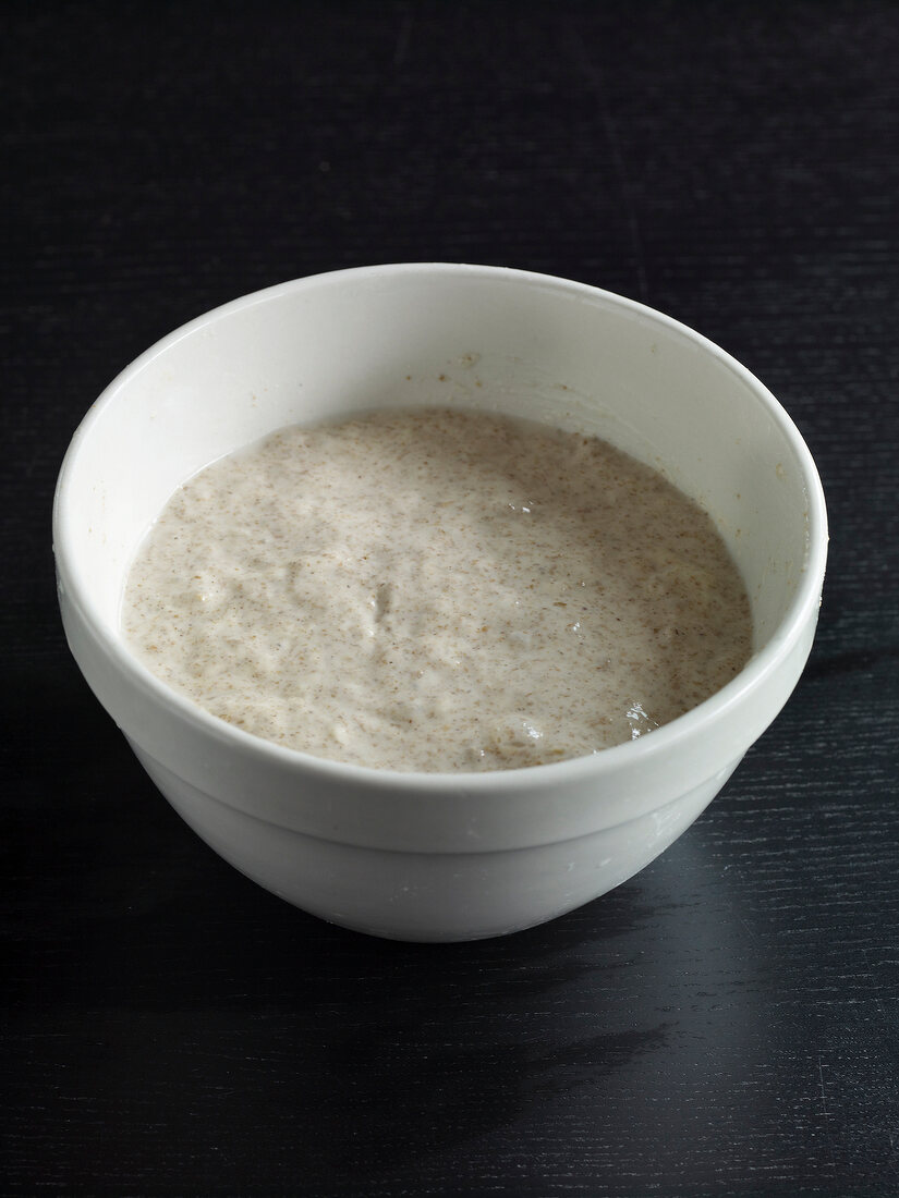 Leaven agent in bowl on black background