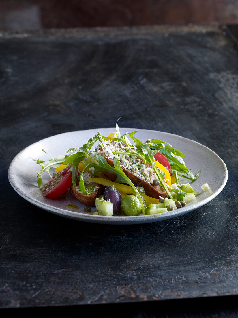 Ciabatta bread salad with arugula on plate