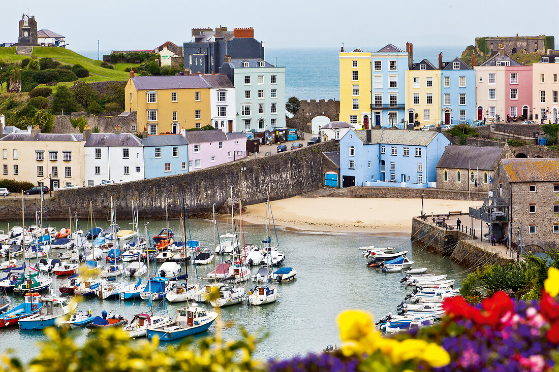 View of colourful buildings and moored boats at Tenby, Pembrokeshire, Wales, UK