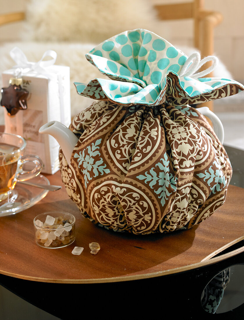 Teapot wrapped in cloth bag to keep tea warm