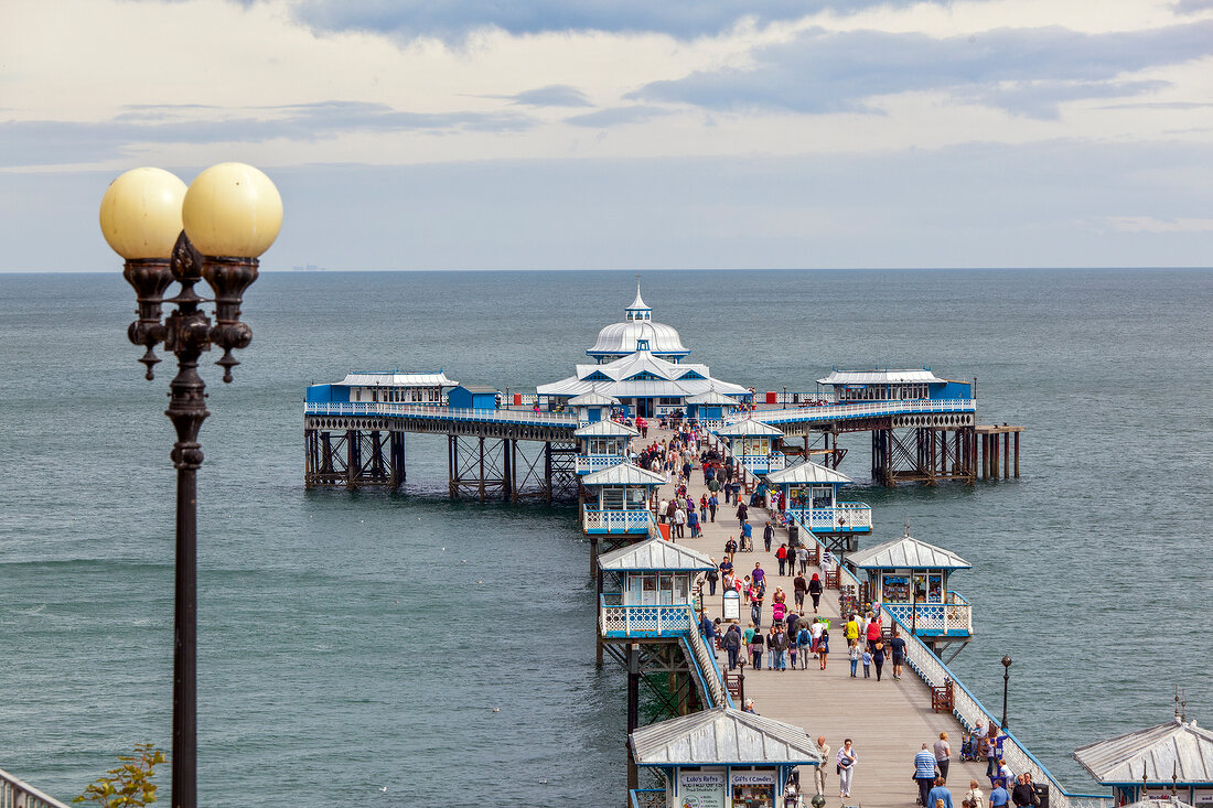 People at Victorian pier at Colwyn Bay, Wales, UK