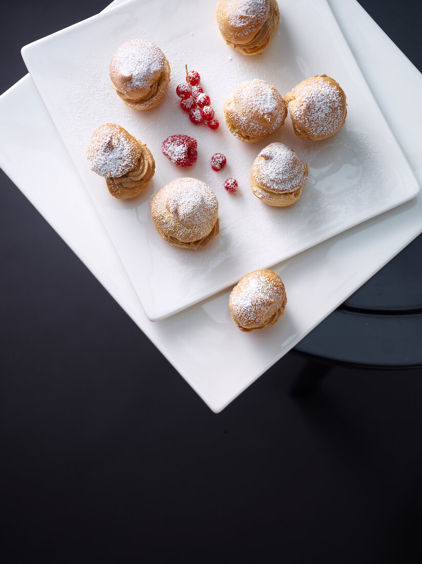 Caramel cream puffs on plate, overhead view