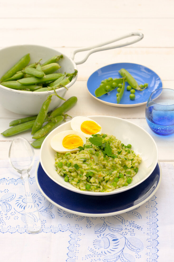Peas risotto with eggs on plate