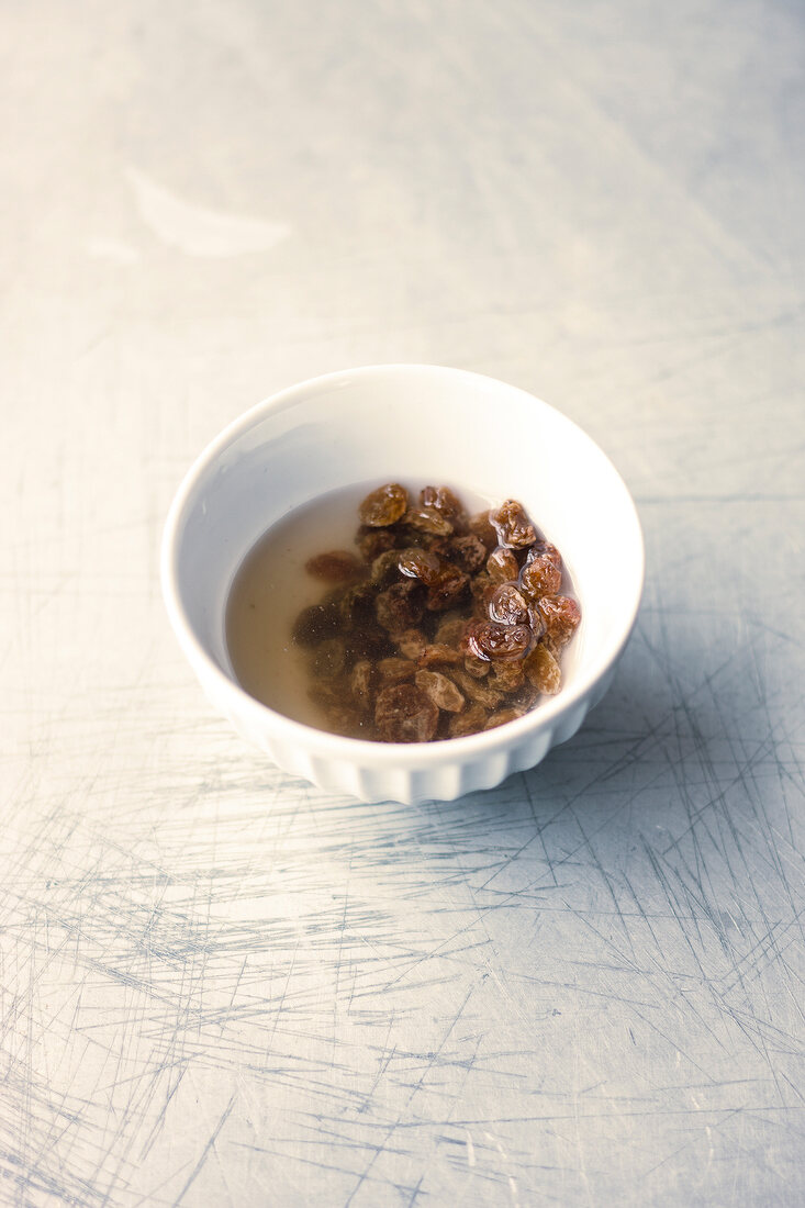 Raisins soaked in bowl of water