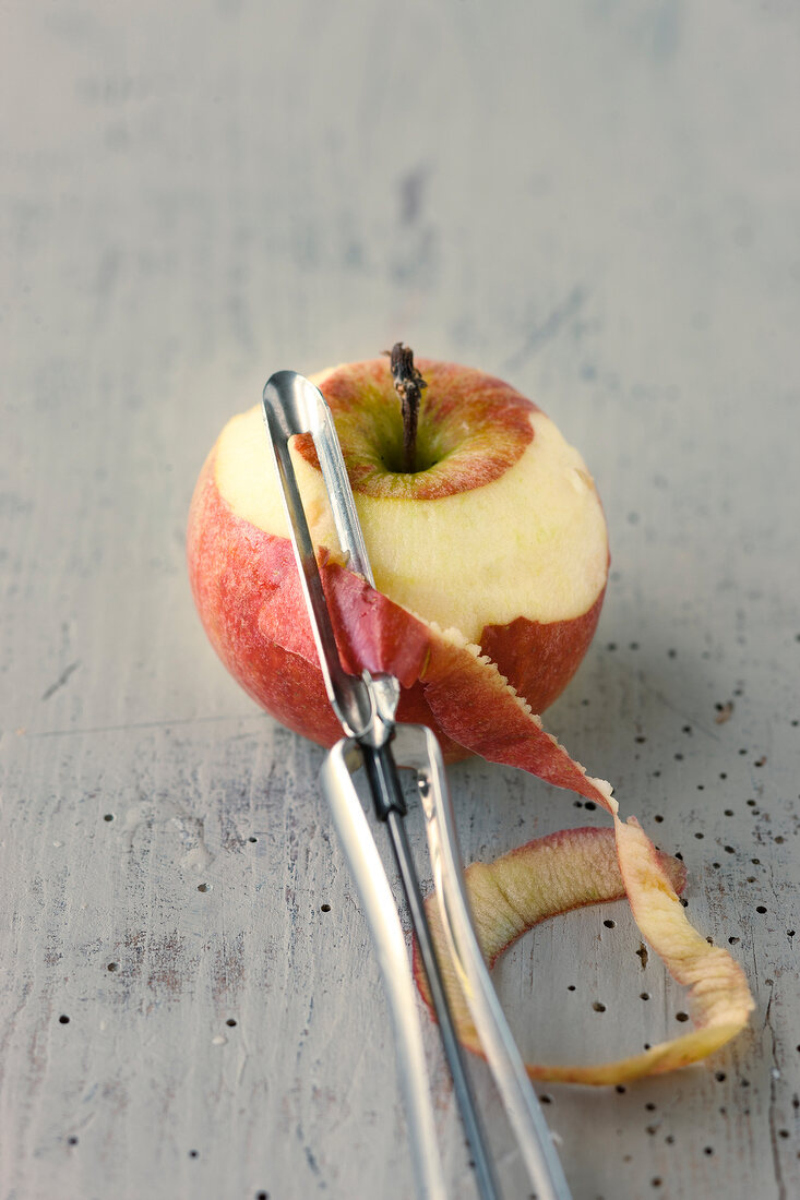 Apple being peeled with peeler
