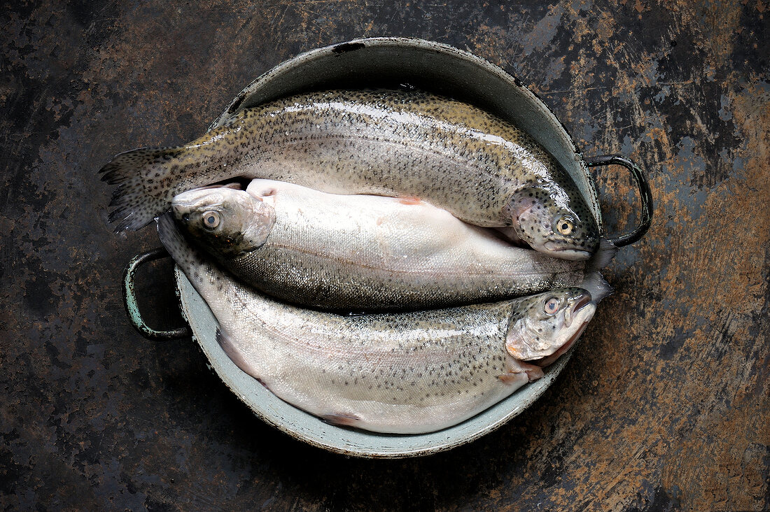 Three trout fish in wok