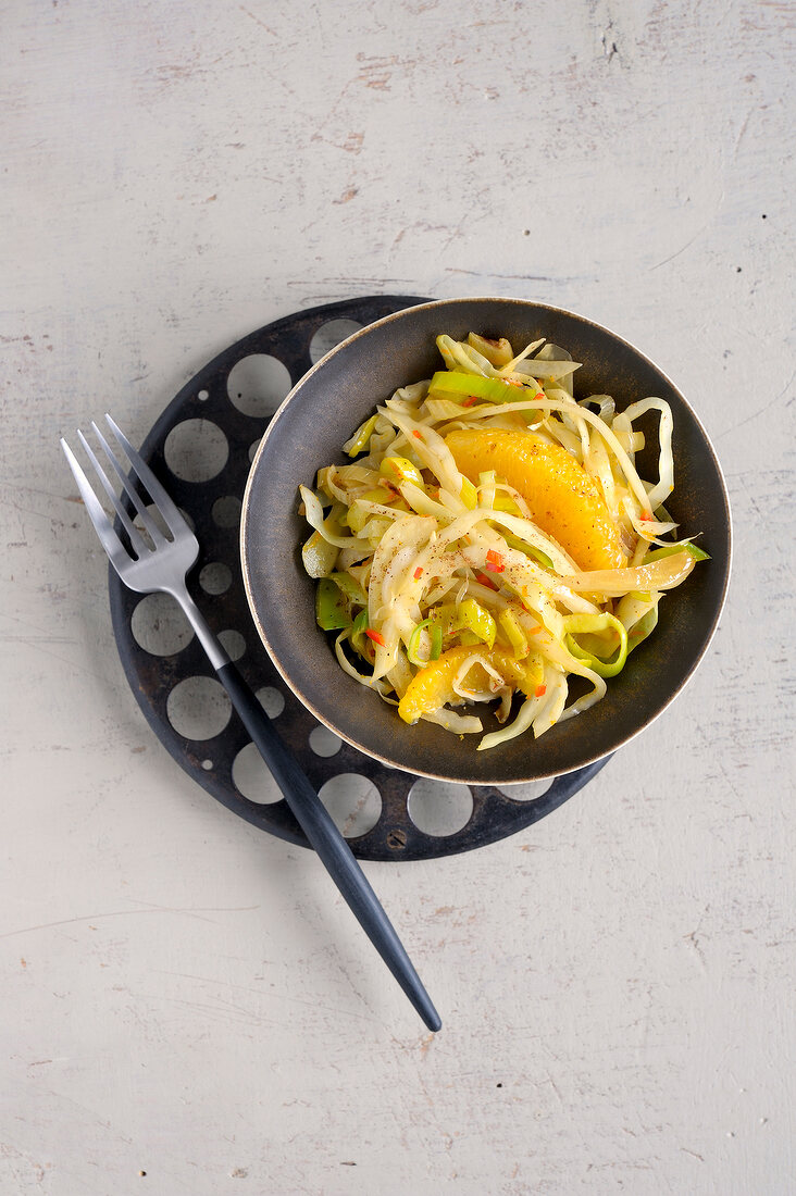 Bowl of orange and leek cabbage, overhead view