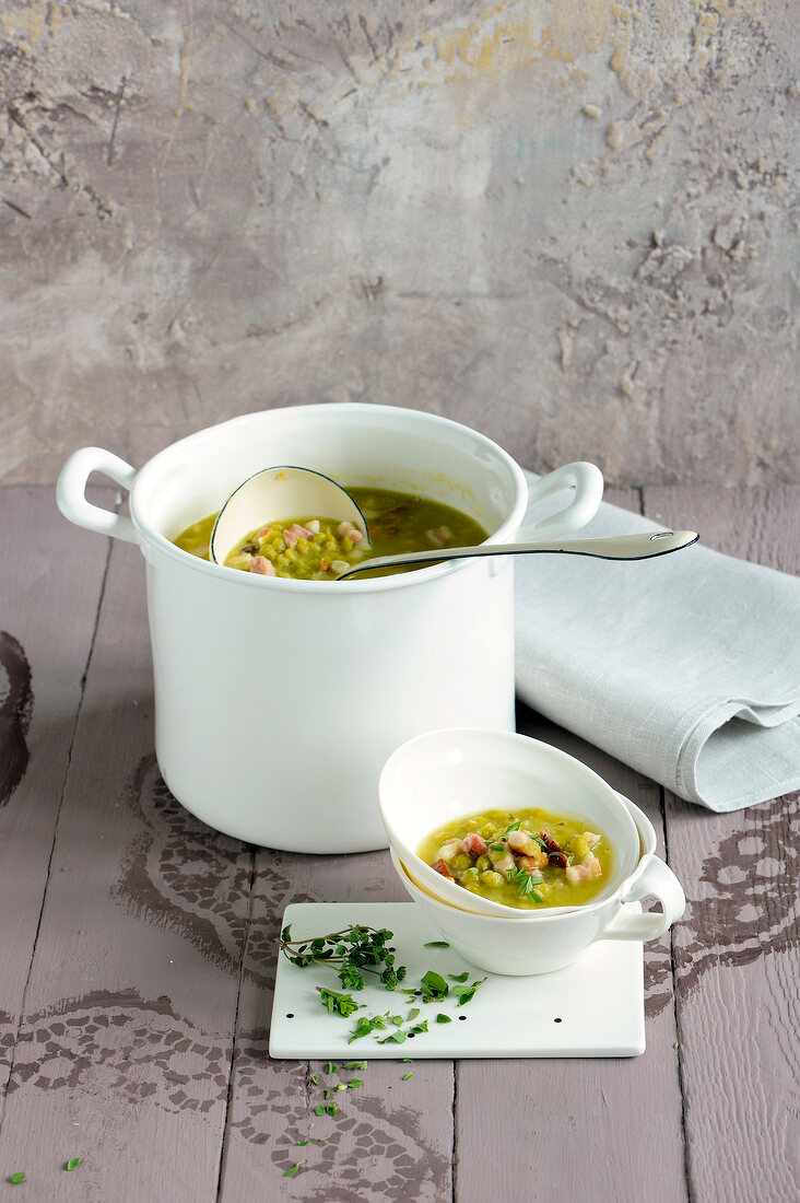 Pea soup in casserole and bowl