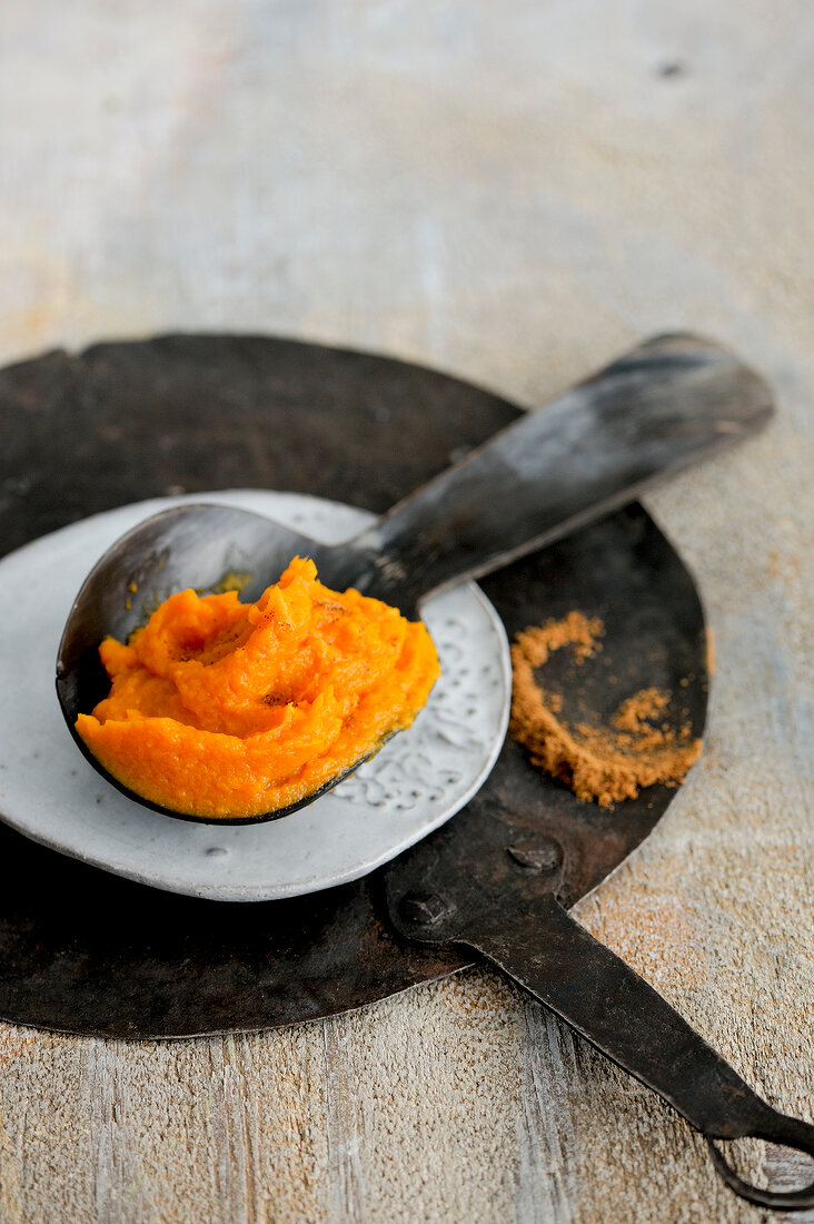 Close-up of sweet potato mash on wooden spoon