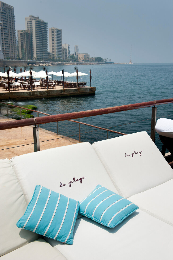 Beach chairs with cushions by the sea at La Plage Beach Club, Beirut, Lebanon