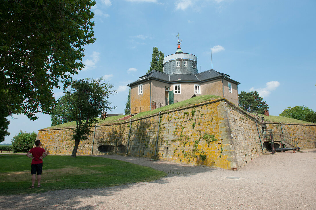 Tourist standing in front of fort at Steinhude, Lower Saxony, Germany