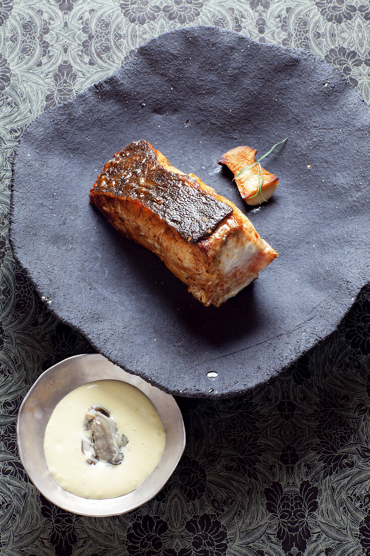 Chop of turbot with porcini mushrooms and bearnaise sauce on plate