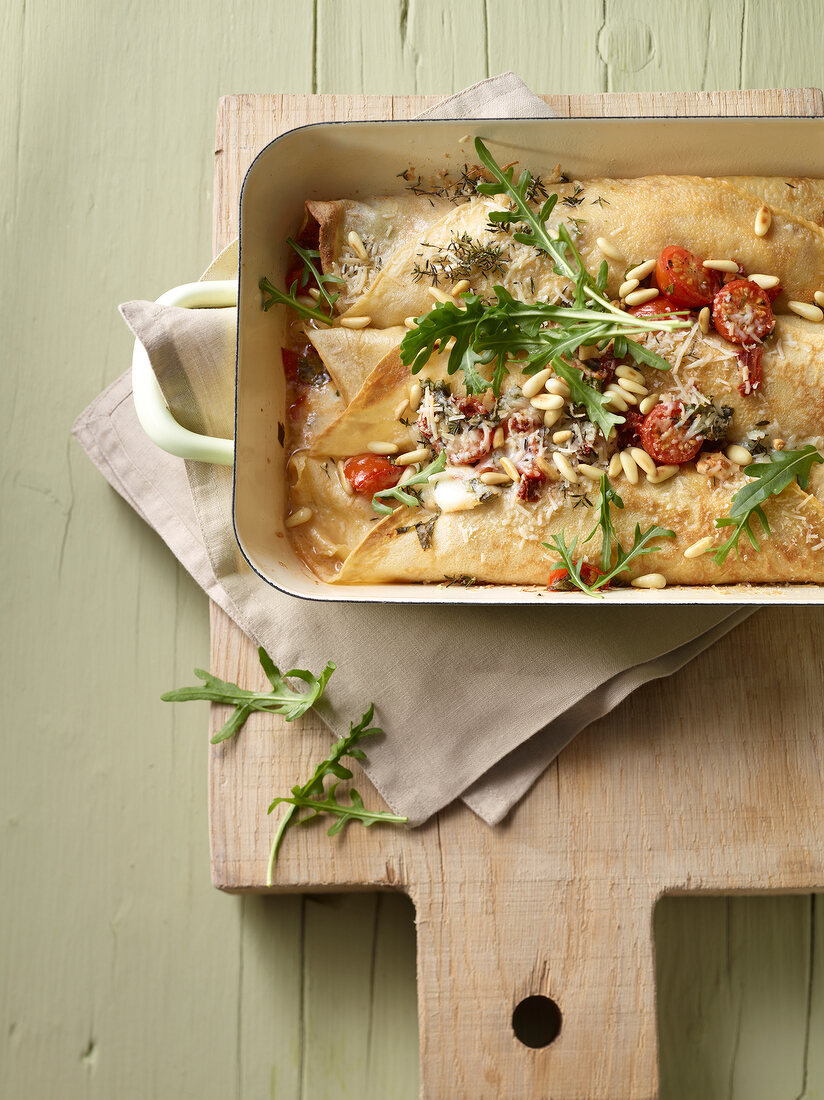 Crepes with Parmesan Caprese filling and rocket in serving dish