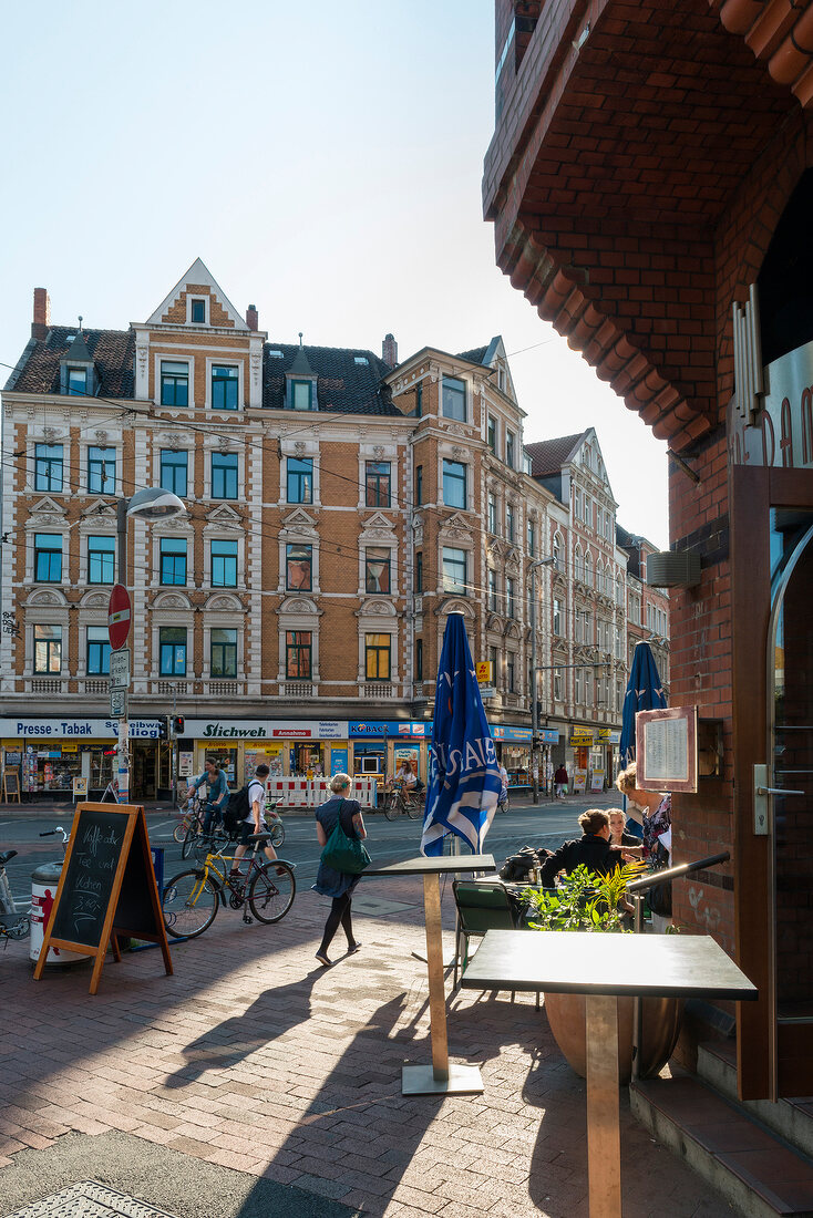 People sitting outside of Cafe Notre Dame in Linden, Hannover, Germany
