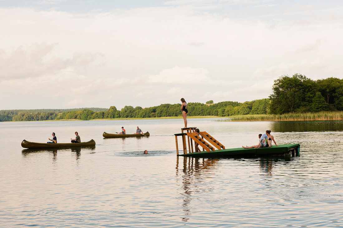 Canoeists and canoe in Breiter Luzin lake, Germany