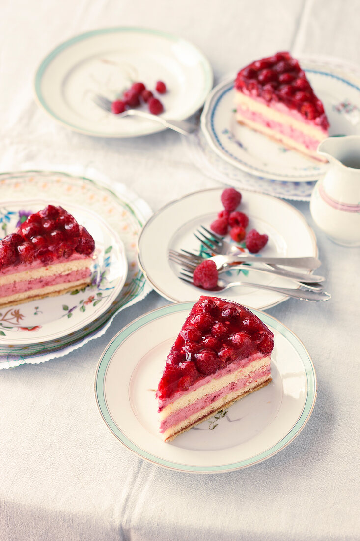 Slices of raspberry cream cake on plates