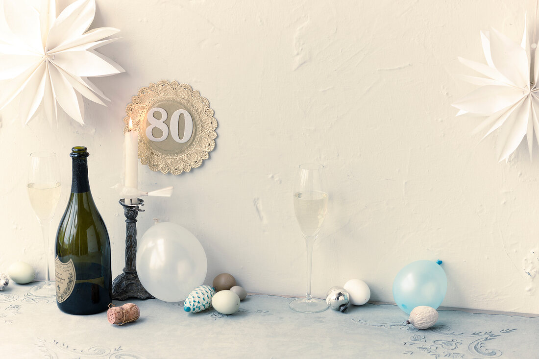Champagne bottle, wine glass, candle stand and party decoration