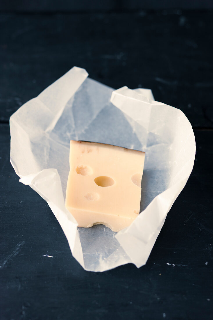Piece of Emmental cheese on baking paper