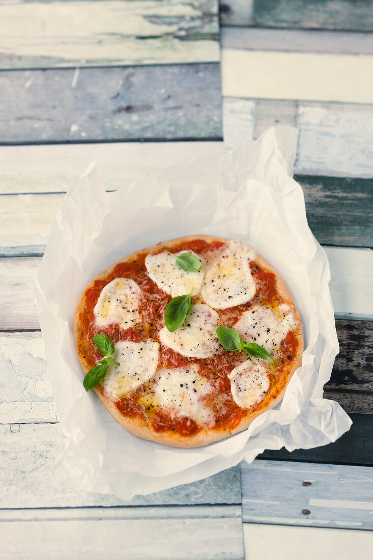 Tomato Mozzarella pizza on tissue paper