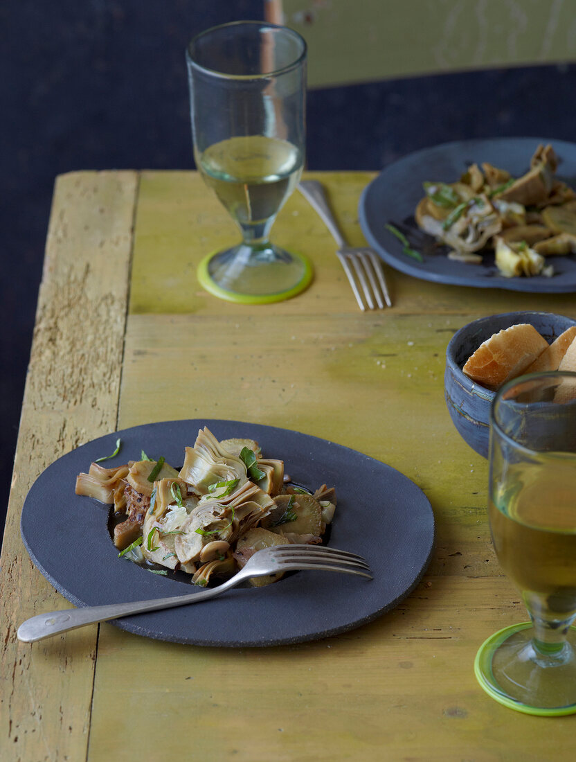 Braised artichokes with lemon and mint on plate