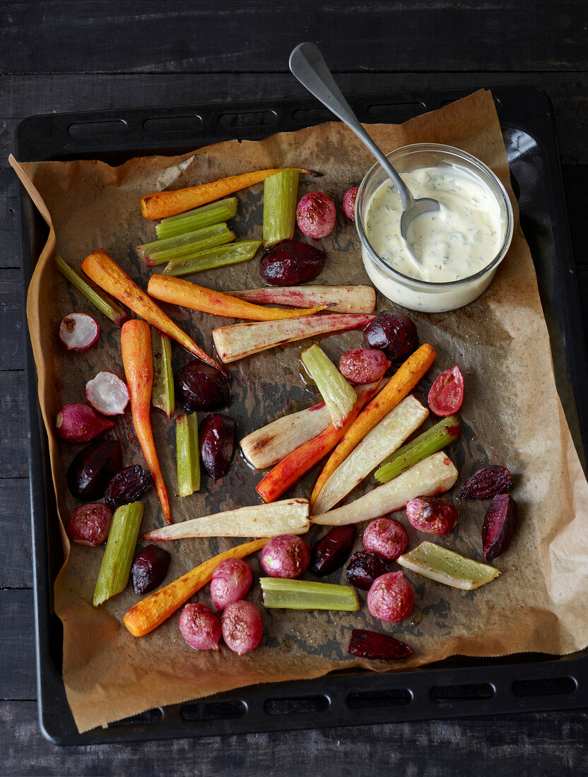 Baby roasted vegetables with sour cream aioli on serving dish