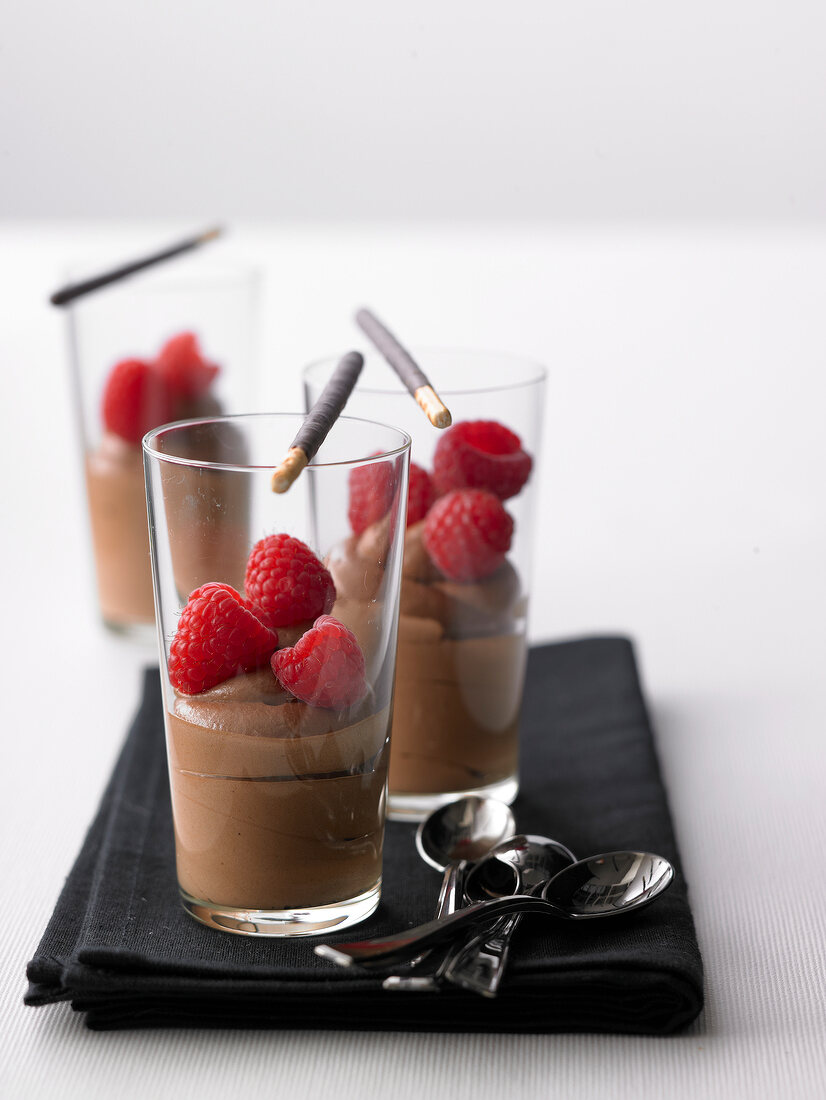 Praline cream with raspberries in glass