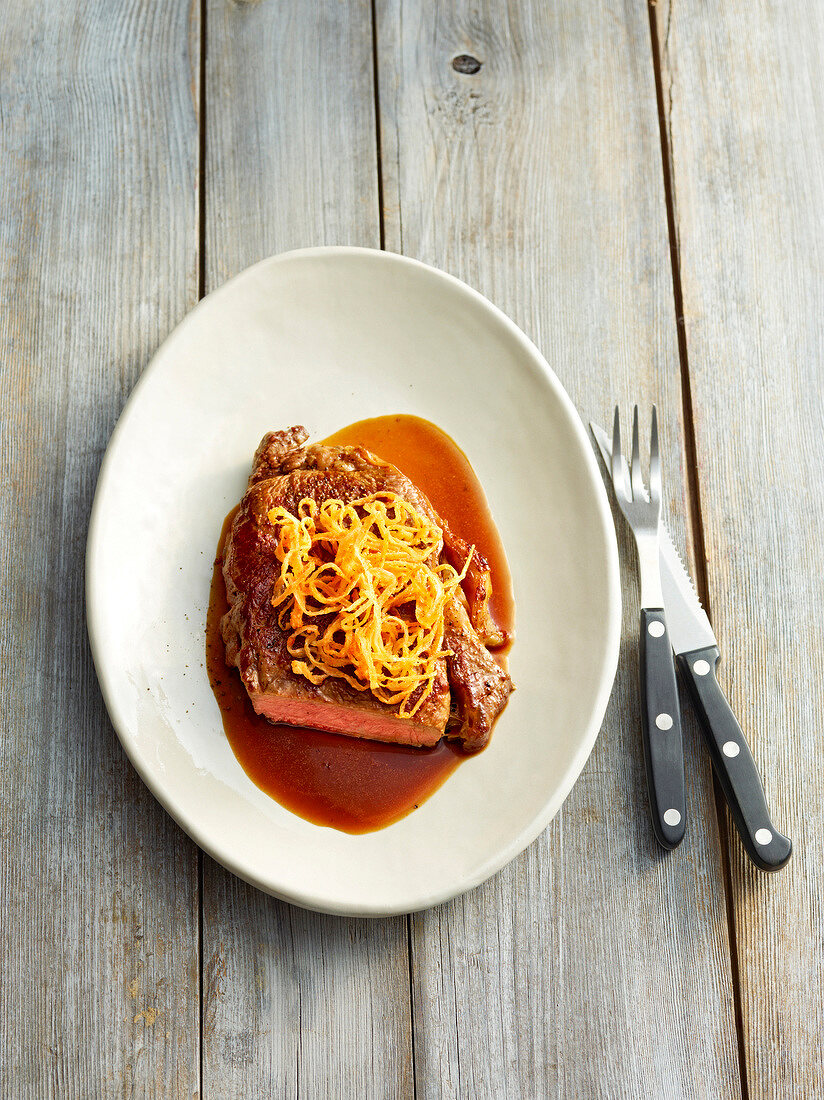 Beef with brown sauce on plate, Bavaria, Germany