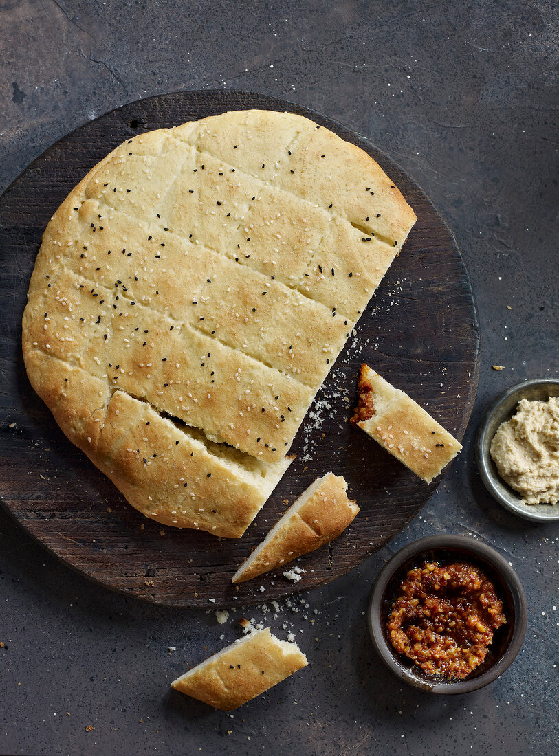 Sliced Turkish pita bread on wooden board