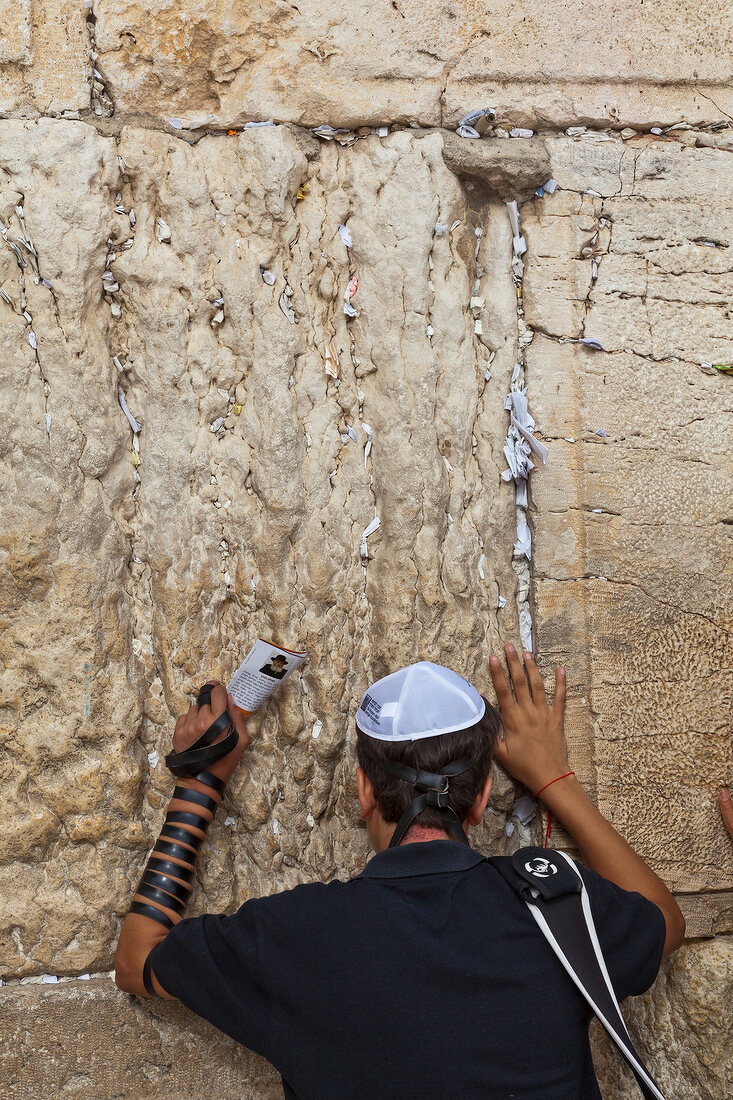 Rear view of man praying on Wailing Wall, Jerusalem, Israel