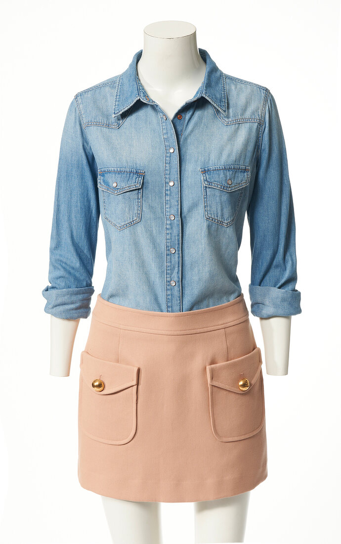 Denim shirt and mini skirt on mannequin on white background