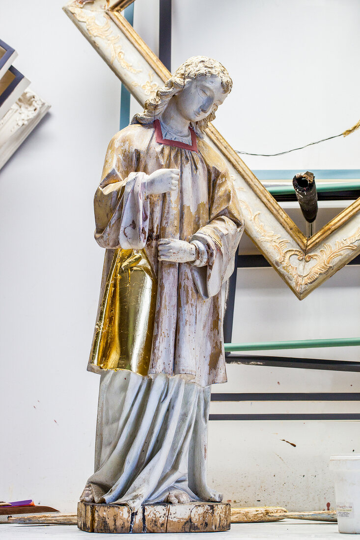 Half restored nayivity angel figure with golden robe