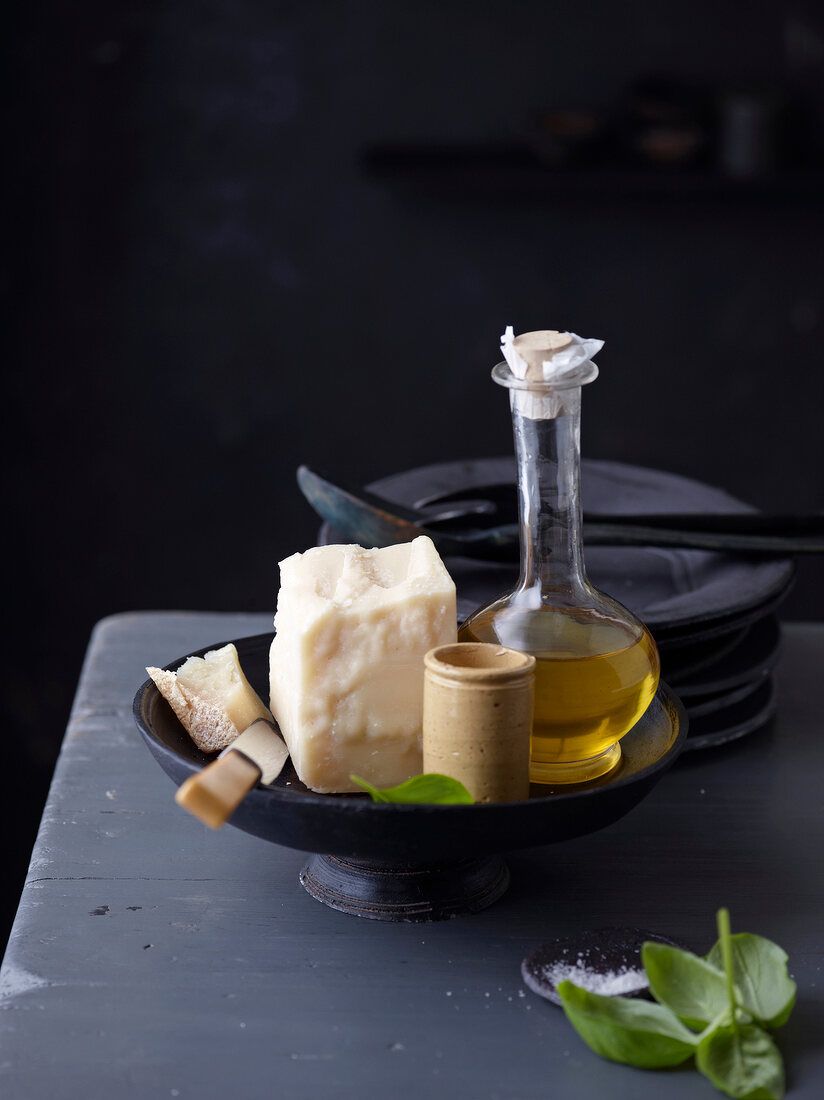 Parmesan cheese and olive oil bottle in serving bowl