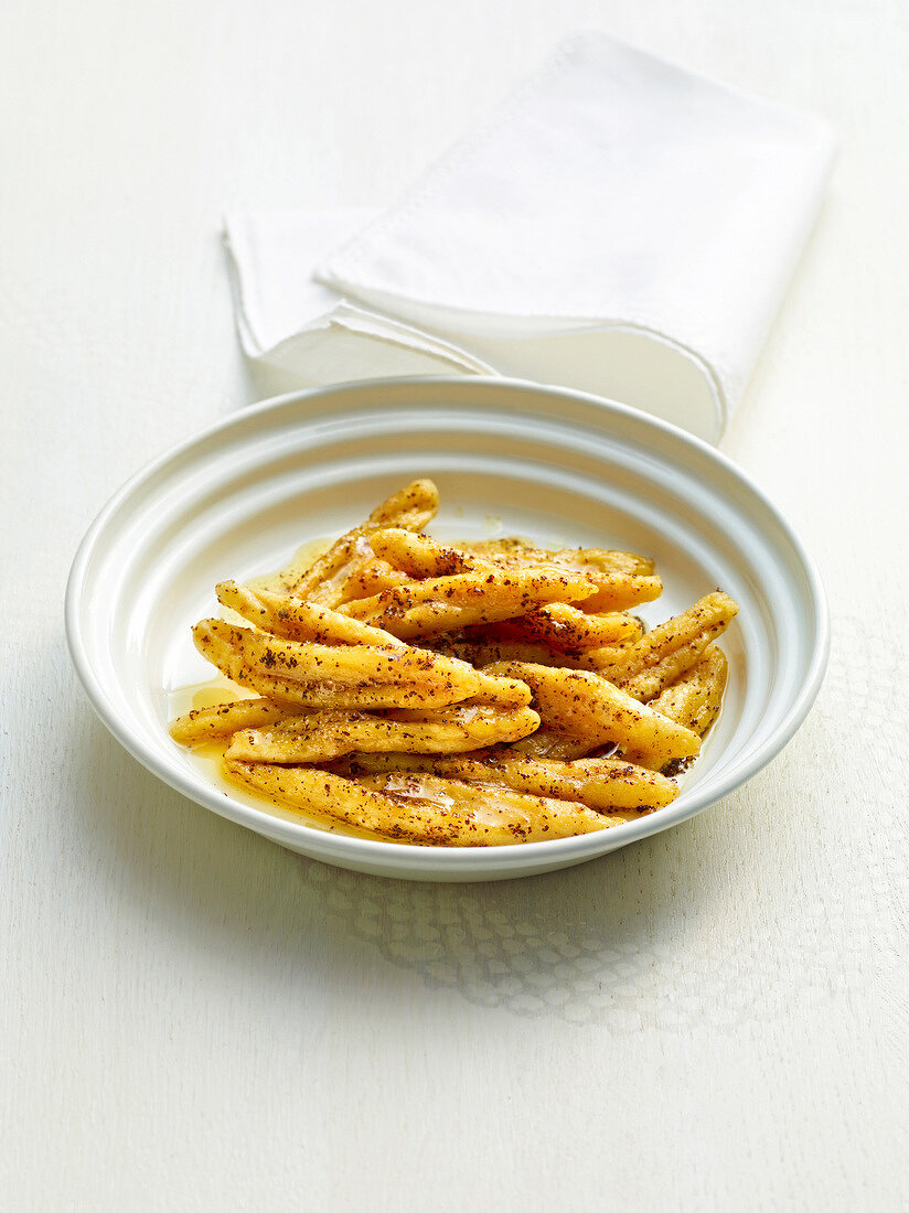 Potato noodles with poppy seeds, butter and vanilla in bowl, Bavaria, Germany