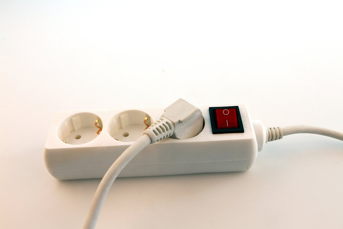 Close-up of triple plug extension on white background